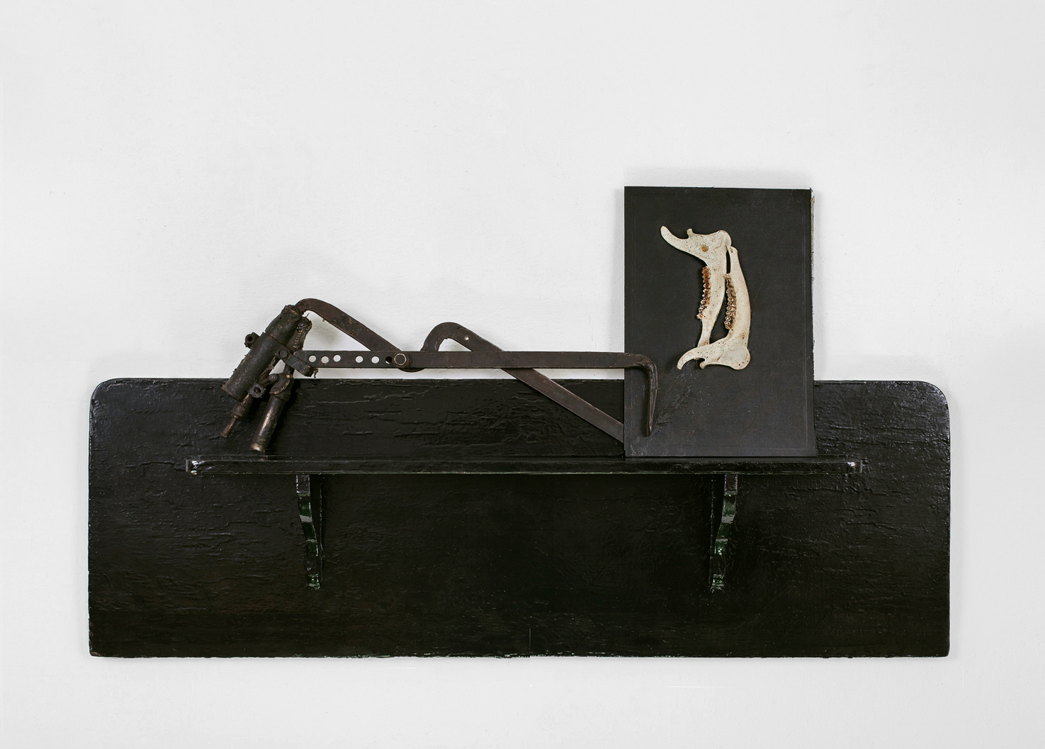 POSSESIA / Implement V / 2013 / 50 x 100 x 12 cm /
shelf, old horse anatomy atlas cover, animal mandibles, tool, machinery parts